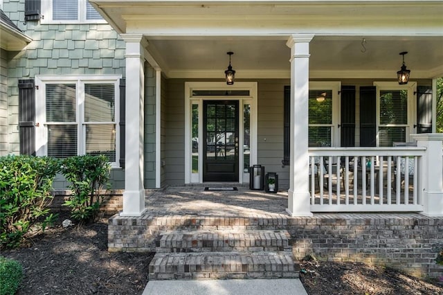 doorway to property featuring covered porch