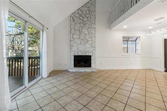 unfurnished living room with light tile patterned floors, crown molding, a fireplace, and high vaulted ceiling