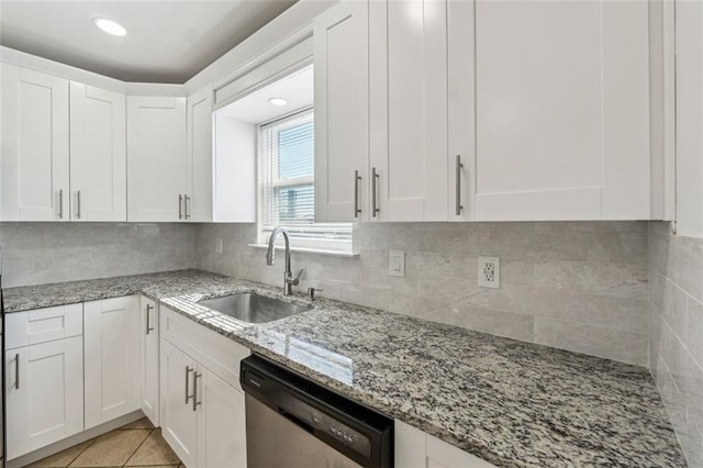 kitchen featuring sink, light stone countertops, white cabinets, and dishwasher