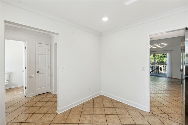 unfurnished room featuring ornamental molding and light tile patterned floors