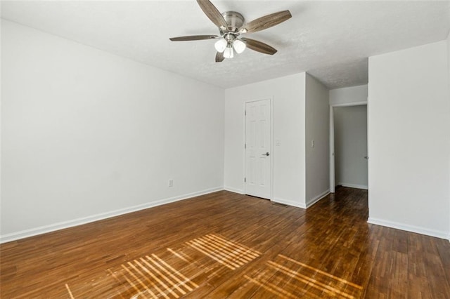 interior space with ceiling fan and dark hardwood / wood-style floors