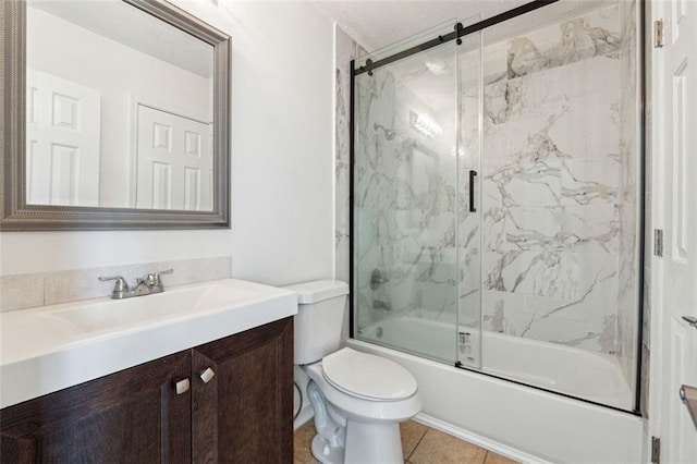 full bathroom with vanity, tile patterned flooring, shower / bath combination with glass door, and toilet