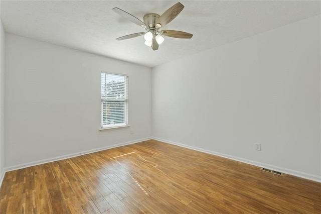 spare room featuring hardwood / wood-style flooring and ceiling fan