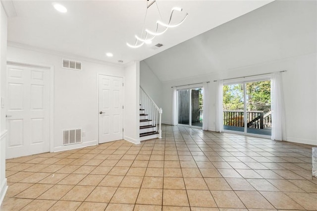 unfurnished room with lofted ceiling, light tile patterned floors, and a chandelier