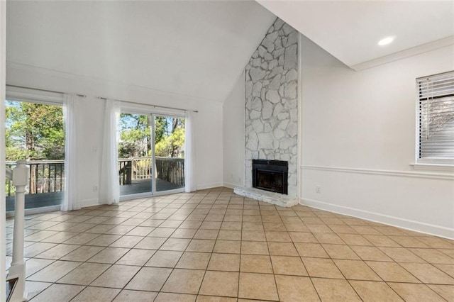 unfurnished living room featuring a fireplace, high vaulted ceiling, and light tile patterned floors