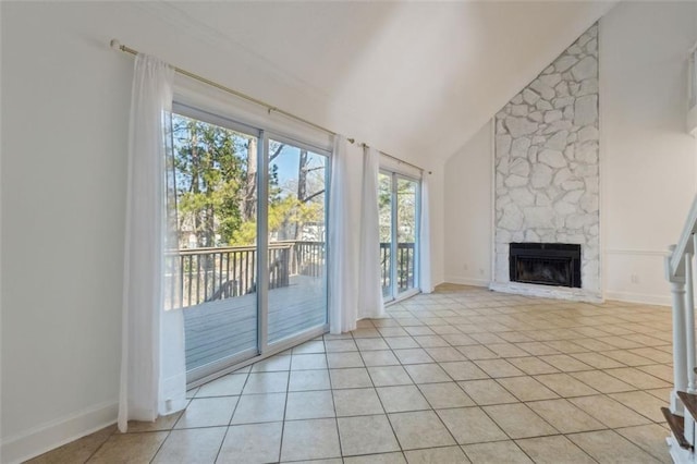 unfurnished living room featuring high vaulted ceiling, light tile patterned floors, and a fireplace