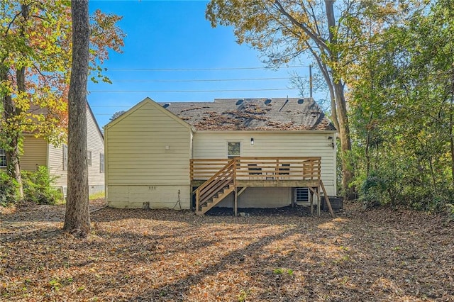 rear view of house featuring crawl space, a shingled roof, stairs, and a deck