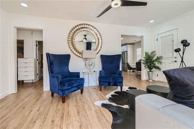 sitting room with light wood-style floors, ceiling fan, baseboards, and recessed lighting