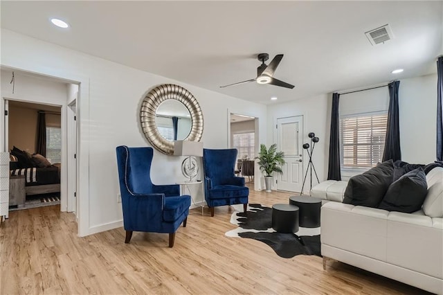 living area featuring ceiling fan, light wood-style flooring, visible vents, and recessed lighting