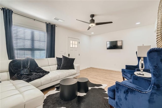 living area with recessed lighting, visible vents, ceiling fan, wood finished floors, and baseboards