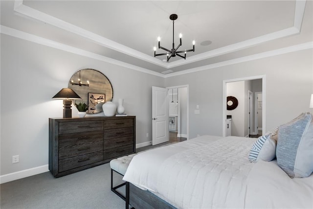 bedroom with a chandelier, carpet flooring, and a raised ceiling