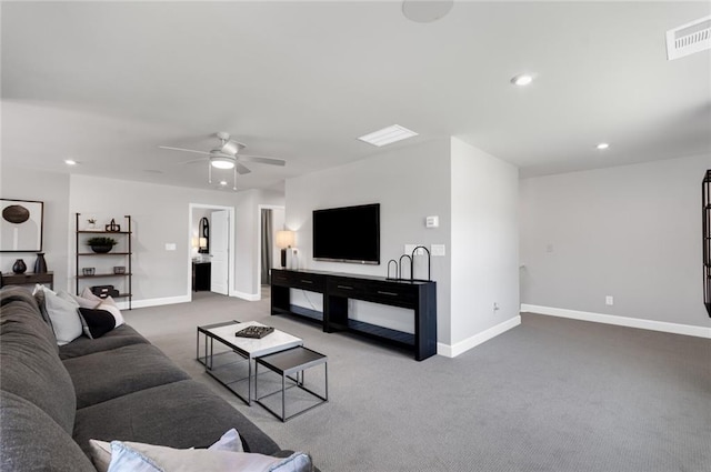 carpeted living room with ceiling fan