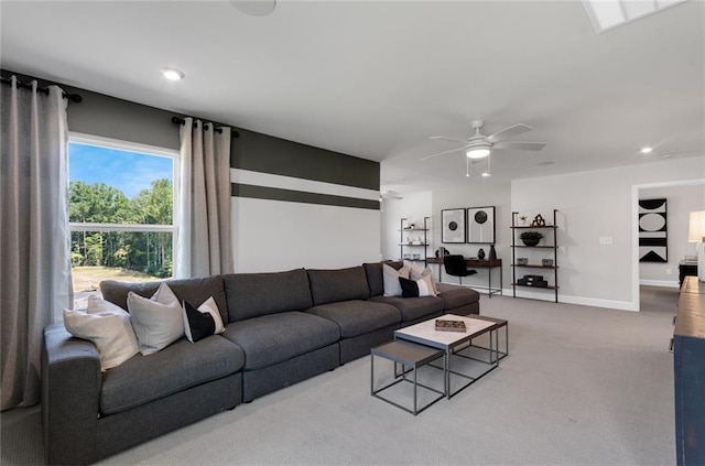 carpeted living room with ceiling fan