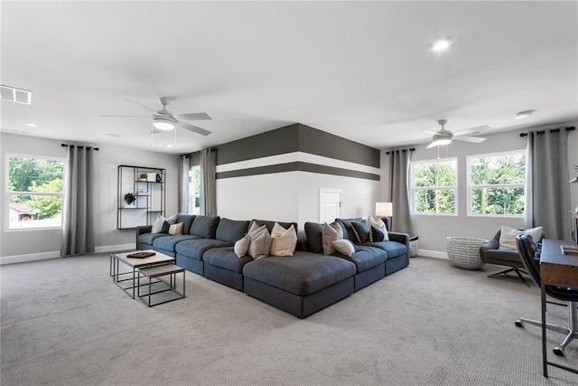 living room featuring a wealth of natural light, light colored carpet, and ceiling fan