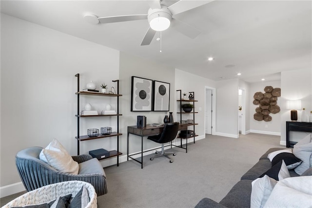 carpeted office space with ceiling fan