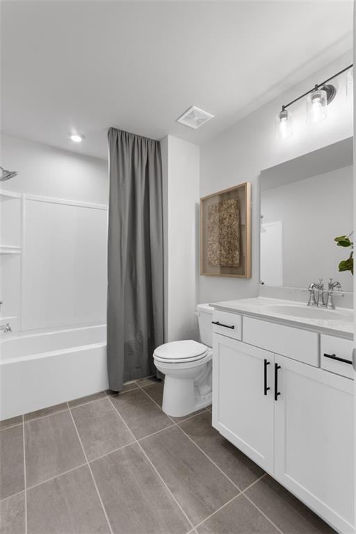 full bathroom with vanity, tile patterned floors, toilet, and shower / tub combo