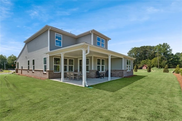 back of property with a lawn and a patio area