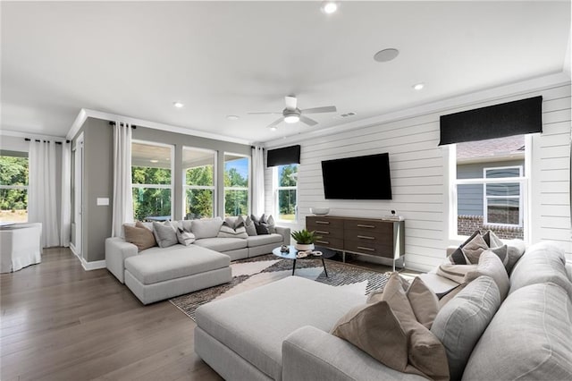 living room featuring crown molding, hardwood / wood-style flooring, ceiling fan, and plenty of natural light