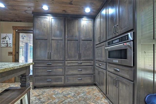 kitchen with wooden ceiling, brick floor, oven, and recessed lighting