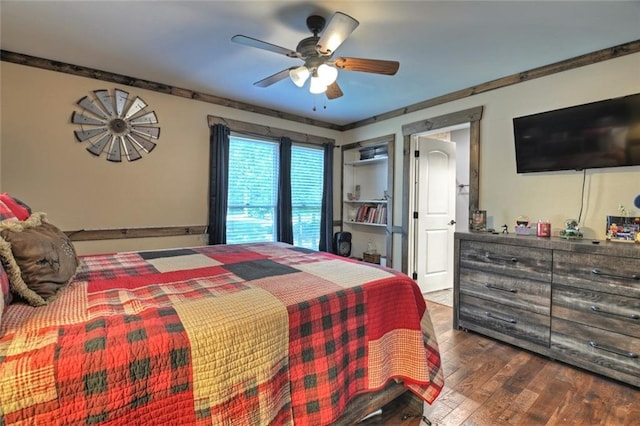 bedroom featuring ceiling fan, ornamental molding, and hardwood / wood-style flooring