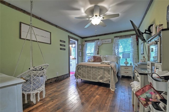 bedroom featuring ornamental molding, dark wood finished floors, baseboards, and a ceiling fan