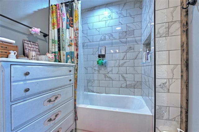 bathroom featuring shower / bath combo with shower curtain and vanity