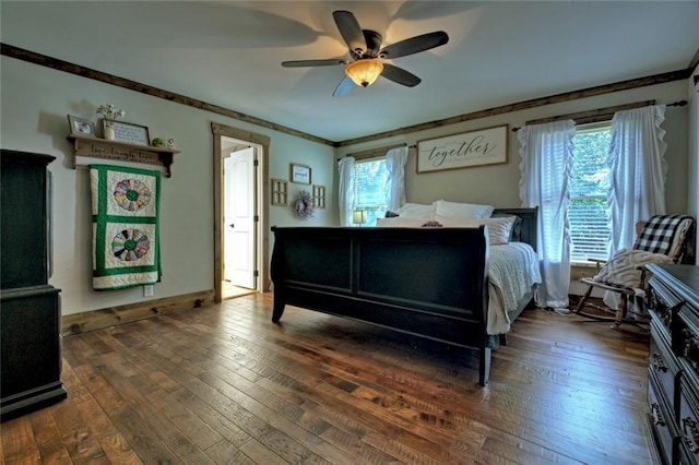 bedroom featuring dark wood-style floors, ceiling fan, multiple windows, and baseboards