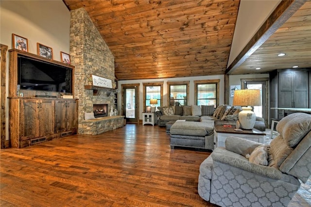 living area with high vaulted ceiling, a stone fireplace, wooden ceiling, wood finished floors, and visible vents