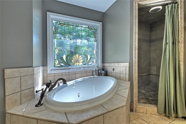 full bathroom featuring a sink, tile patterned flooring, a tile shower, and a bath