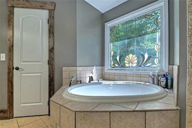 bathroom featuring tile patterned flooring and a bath