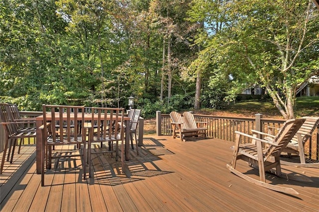 wooden terrace featuring outdoor dining space