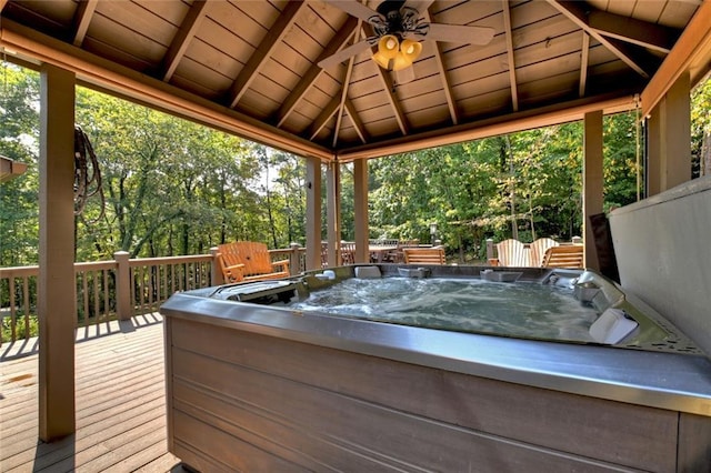 deck featuring a hot tub, ceiling fan, and a gazebo