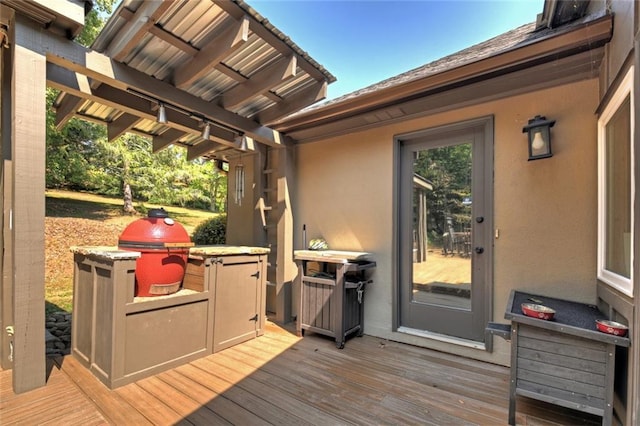 wooden terrace featuring grilling area