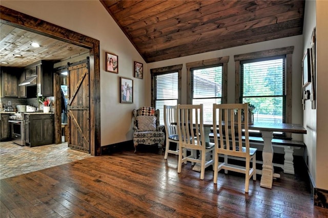 dining space with wooden ceiling, hardwood / wood-style flooring, a barn door, and vaulted ceiling