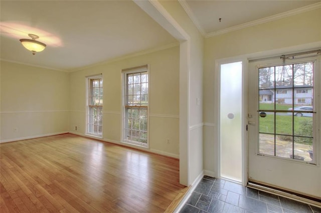 doorway to outside with a wealth of natural light, baseboards, ornamental molding, and wood finished floors