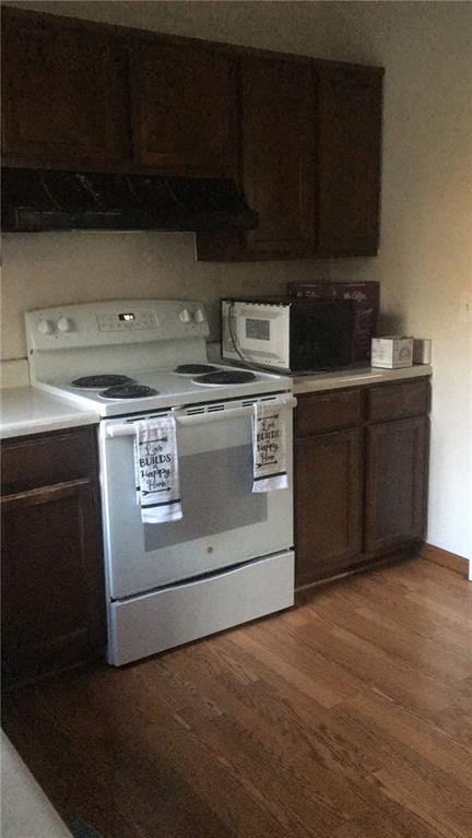 kitchen featuring extractor fan, white appliances, wood-type flooring, and dark brown cabinets