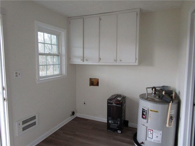 washroom with electric water heater, baseboards, washer hookup, dark wood-style floors, and electric dryer hookup