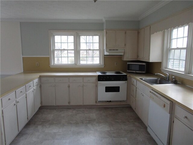 kitchen featuring under cabinet range hood, a sink, white appliances, crown molding, and light countertops