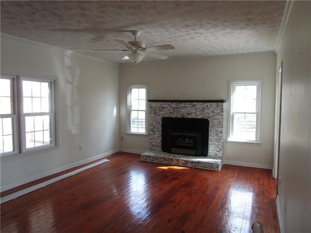unfurnished living room with baseboards, wood-type flooring, and a textured ceiling