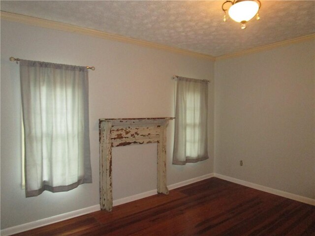 unfurnished living room featuring crown molding, wood finished floors, and baseboards