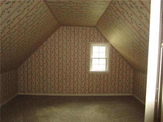bonus room with wallpapered walls, carpet floors, and vaulted ceiling