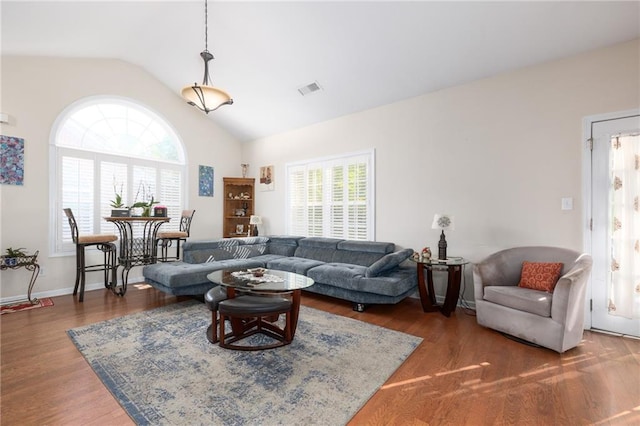 living room with lofted ceiling and dark hardwood / wood-style flooring