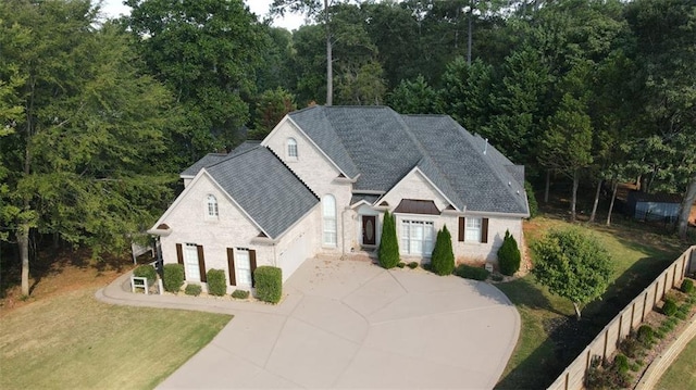 255 Carriage Station Dr, Lawrenceville, GA 30046 - view of front of home with concrete driveway, an attached garage, a front lawn, and stone siding