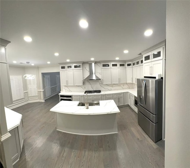 255 Carriage Station Dr, Lawrenceville, GA 30046 - kitchen with wall chimney range hood, stainless steel refrigerator with ice dispenser, a sink, a kitchen island, and dark wood-type flooring
