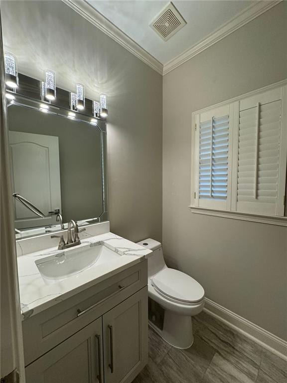 255 Carriage Station Dr, Lawrenceville, GA 30046 - bathroom with toilet, vanity, crown molding, and baseboards
