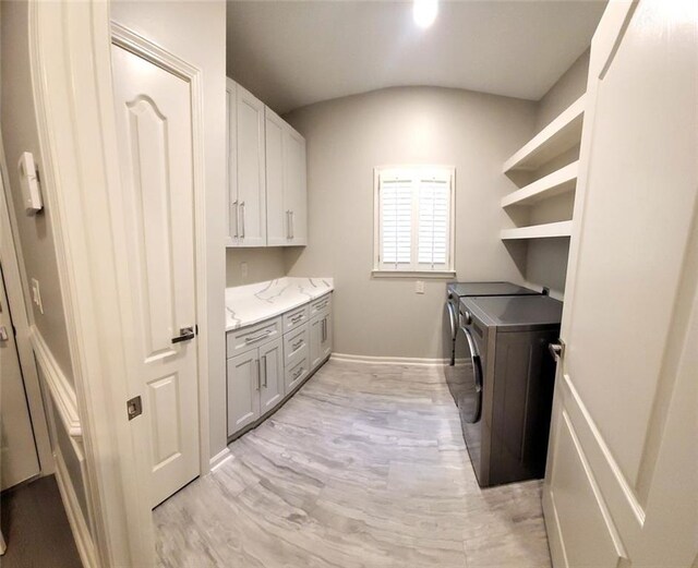 255 Carriage Station Dr, Lawrenceville, GA 30046 - washroom with washer and dryer, light wood-type flooring, cabinet space, and baseboards
