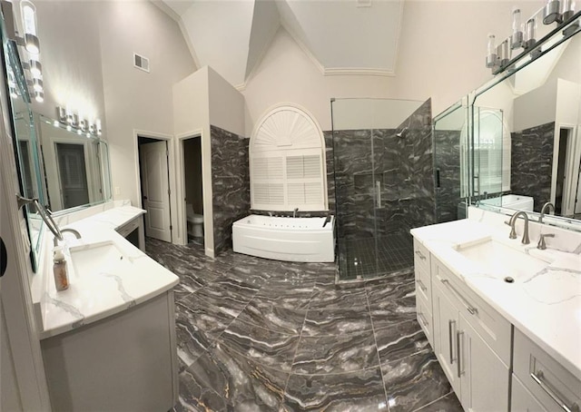 255 Carriage Station Dr, Lawrenceville, GA 30046 - bathroom with marble tiled floors, a bath, a shower stall, two vanities, and lofted ceiling