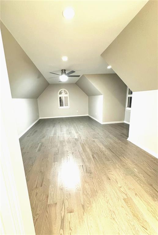 255 Carriage Station Dr, Lawrenceville, GA 30046 - additional living space featuring baseboards, wood finished floors, lofted ceiling, and recessed lighting