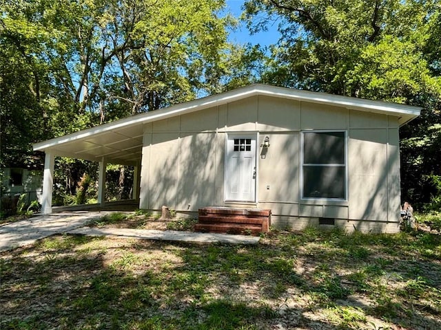 2489 Hillside Dr, Macon, GA 31206 - view of front facade with crawl space, entry steps, a carport, and driveway