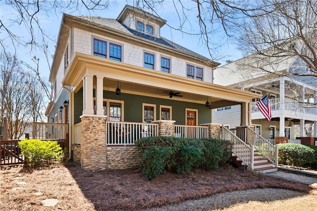 american foursquare style home featuring a porch and ceiling fan